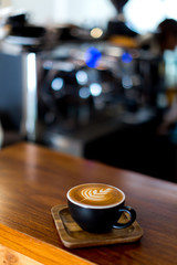 coffee latte art on wooden table in a cafe