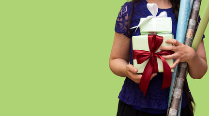closeup woman holding gift boxes and paper for the preparation of christmas