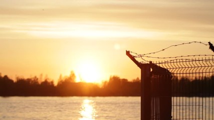 barbed wire fence - Powered by Adobe