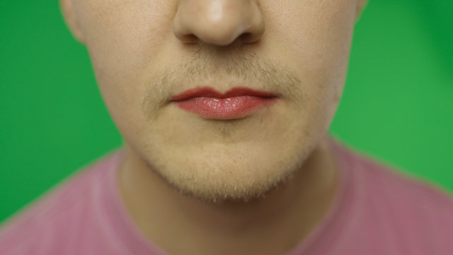 Bearded man with painted red lips. LGBT community. Transsexual guy - Powered by Adobe