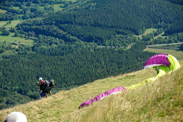 Paragliders preparing for takeoff at the summit of Puy de Dome