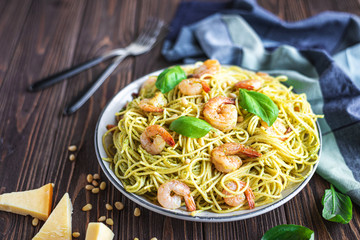 Spaghetti seafood pasta with prawns and basil. Pasta with pesto and prawns.