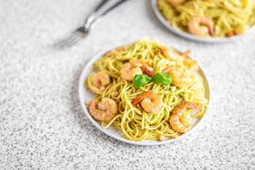Spaghetti seafood pasta with prawns and basil. Pasta with pesto and prawns.