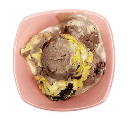 Chocolate, vanilla and caramel ice cream in porcelain bowl isolated on white background, top view