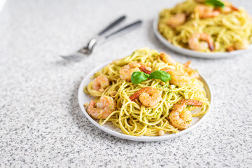 Spaghetti seafood pasta with prawns and basil. Pasta with pesto and prawns.