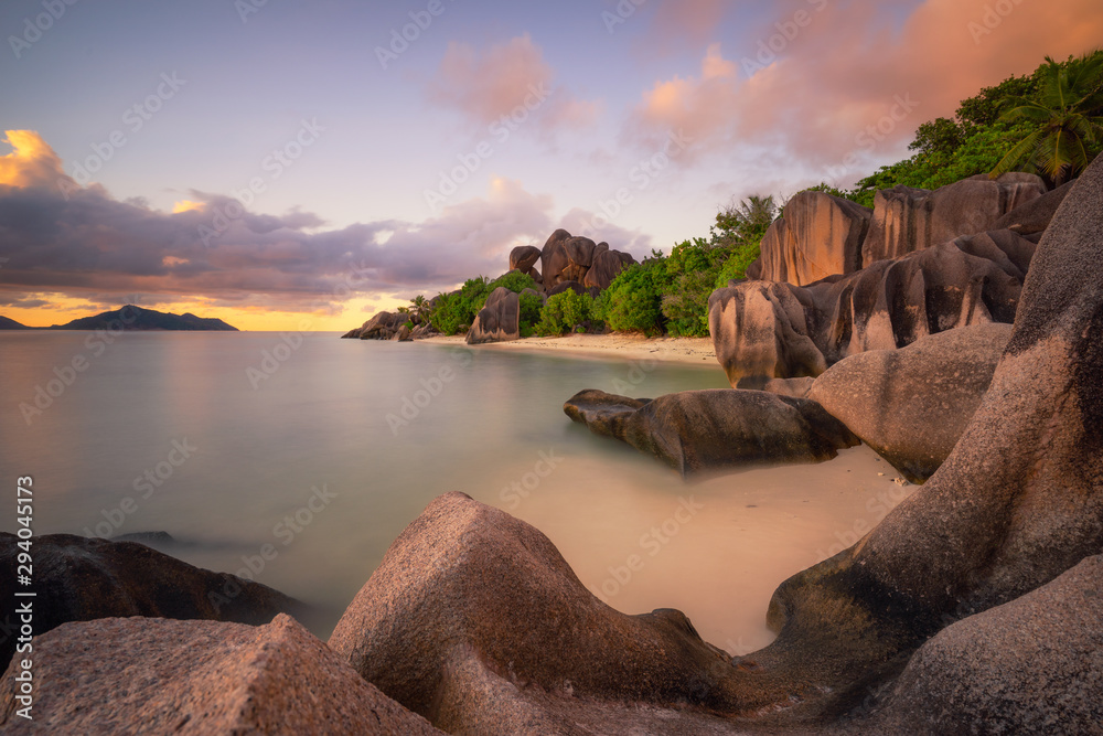 Wall mural granite boulders in sunset soft light at anse source d'argent beach, la digue island, seychelles