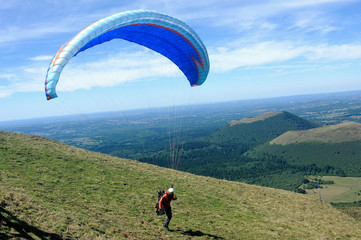 Paragliders preparing for takeoff at the summit of Puy de Dome