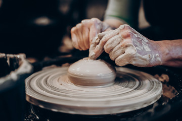 master makes a vase of clay, clay circle, close-up hands, mug of raw clay, hands made
