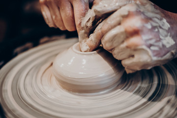 master makes a vase of clay, clay circle, close-up hands, mug of raw clay, hands made