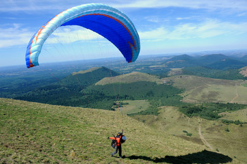 Paragliders preparing for takeoff at the summit of Puy de Dome