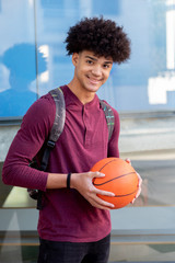 African guy in the university with a basket ball