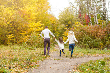 Fototapeta premium Family with child go in autumn park