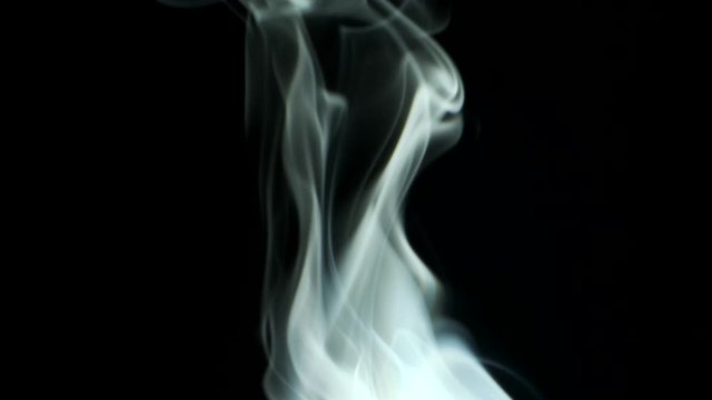 Trickle smoke rising graceful twists upward. Cigar smoke blowing from bottom to top. Natural color tobacco smoke. Great for editing, video without color correction and grading, 4K - 60fps