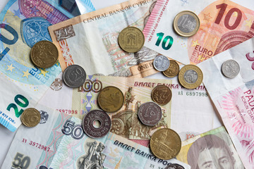 Verschiedene Währungen als Münzen und Geldscheine stehen für globale Finanzmärkte, Geldtransfer, Wechselkurse, die Notwendigkeit von Krypto-Währungen, den Wechsel hin zur digitalen Finanzwelt