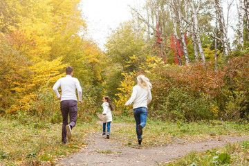 Fototapeta premium Family with child go in autumn park