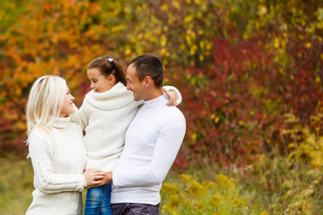 Family with child go in autumn park