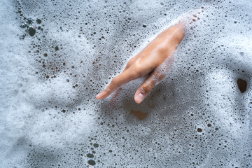 Caucasian woman hand emerging from the water