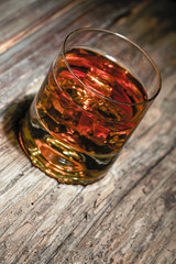 glass of whiskey on wooden