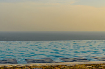 Infinity pool with crystal blue water view to sea  ocean