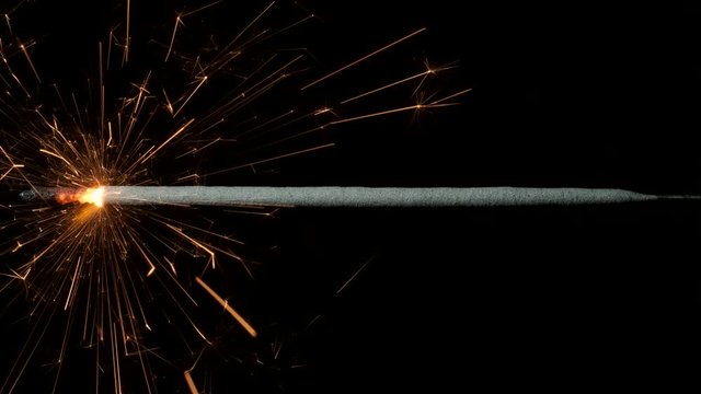 Vivid Christian sparklers, Vibrant bengal lights on black background. Bright firework sparkler burning on dark background. Closeup 