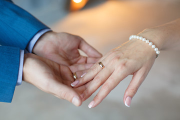 Bride's and Groom's hands with wedding rings