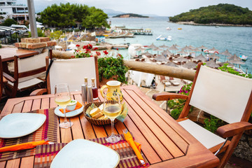 Restaurant with served table in seafront of Ionian sea, Ksamil