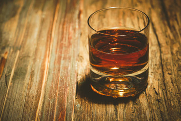 glass of whiskey on wooden