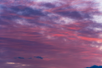Sunset with cloudy sky, cirrus clouds, blues, pinks and purples, nature background