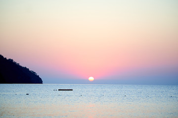 Fototapeta na wymiar Sunset above sea with boat in Turkey