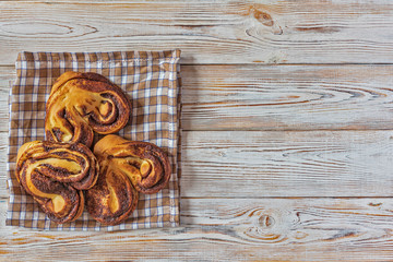 Cinnamon roll on a light wooden background.
