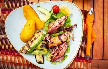 Grilled squid stuffed with vegetables and lemon. Seafood