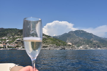 Glass of Champagne view from yacht amalfi coast italy
