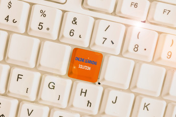 Text sign showing Online Learning Solution. Business photo showcasing use of Electronic access to Educational Curriculum White pc keyboard with empty note paper above white background key copy space