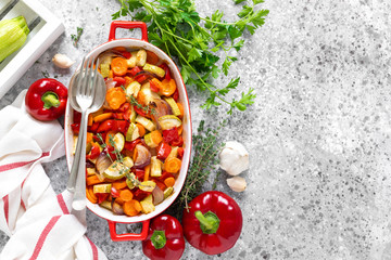 Roasted vegetables. Carrot, zucchini, onion and red pepper oven baked with herbs. Top view