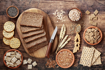 High fibre healthy food concept with wholegrain rye bread, seeded crackers, cereals, grains,...
