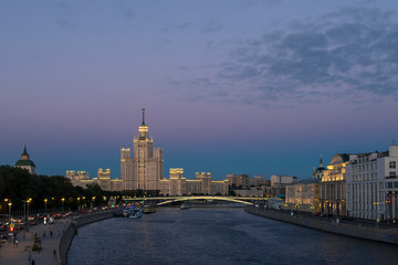 Kotelnicheskaya skyscraper just after sunset. Bolshoi Ust'insky bridge over Moscow river. Russia..