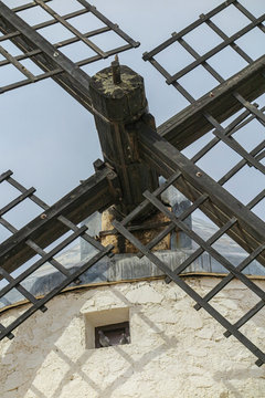 closeup of the rotor and wooden blades of an old windmill 3