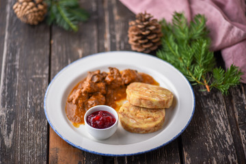 Deer goulash with dumplings and cranberry jam