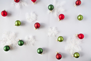 Decorative snow and christmas balls of red and green colors. Christmas concept flat lay