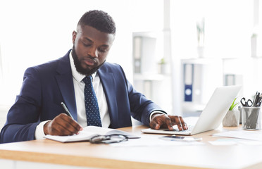 Successful black businessman working hard in office - Powered by Adobe