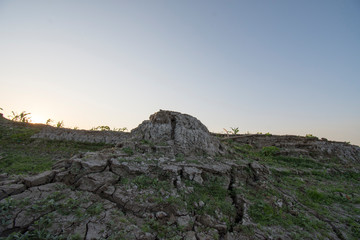 The curb erosion from storms. To indicate the layers of soil and rock.
