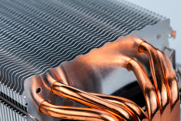 Modern tower heat radiator with six copper heatpipes closeup macro background. Selective focus...