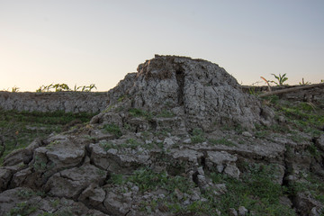The curb erosion from storms. To indicate the layers of soil and rock.