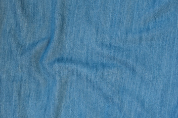 Crumpled denim seamless fabric texture. Dark blue color