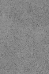 Old cement porous wall made of gray cement with bumps. Abstract colorless background for design and title. Perfectly shows the object. Vertical view