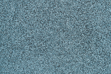 Old blue cement wall with bumps and pores. Dark textured background