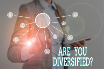 Conceptual hand writing showing Are You Diversified Question. Concept meaning someone who is Different Mixed Multi Faceted Woman wear work suit presenting presentation using smart device