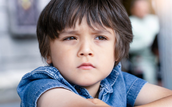 Emotional portrait of Unhappy Toddler boy with sad face, Upset boy standing  alone looking out with deep in thought Kid sad face looking down, Lonely kid  with bored face, Spoiled children Stock Photo | Adobe Stock