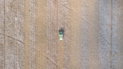 Aerial footage of a Six row Cotton picker working in a large field.