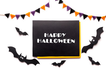 Text on chalkboard with Halloween decorations and bats on white